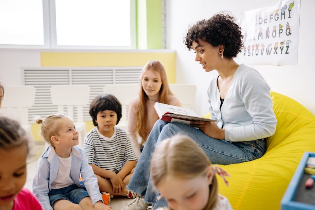 Importance of Strong Foundations in Early Learning Teacher reading to preschool kids in a colorful classroom setting.